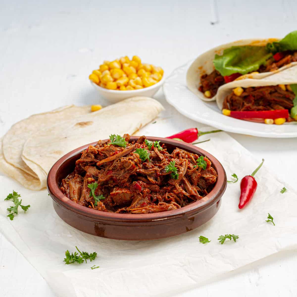 Instant Pot Birria served with chilies and tortillas