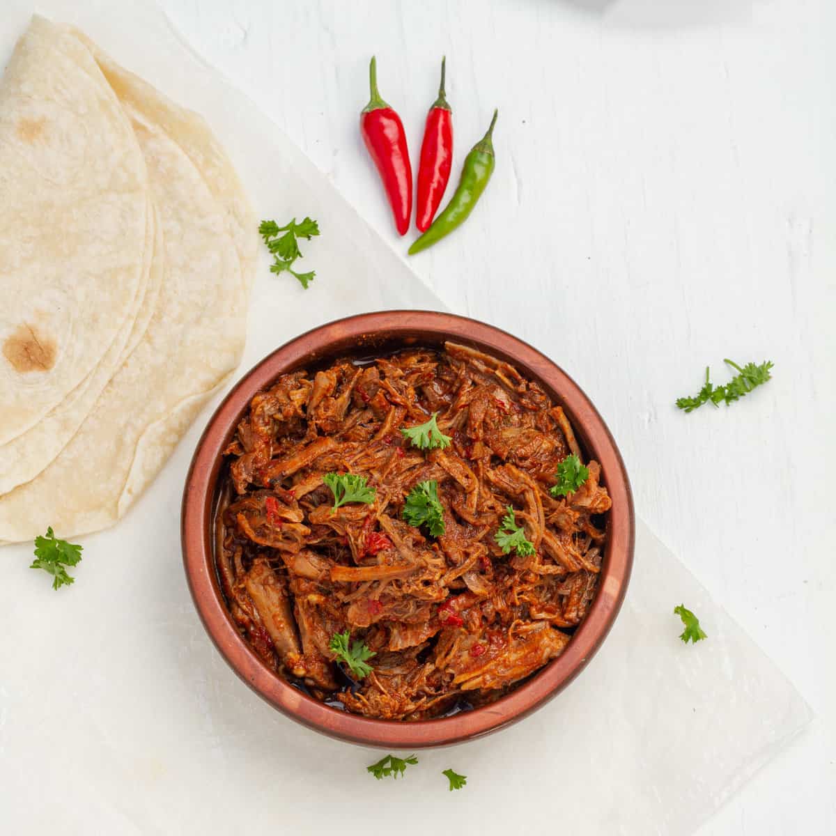 Instant Pot Birria served with chilies and tortillas