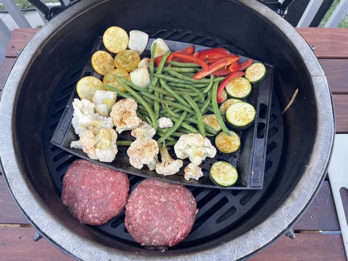 vegetables and meat on a grill ready to be cooked