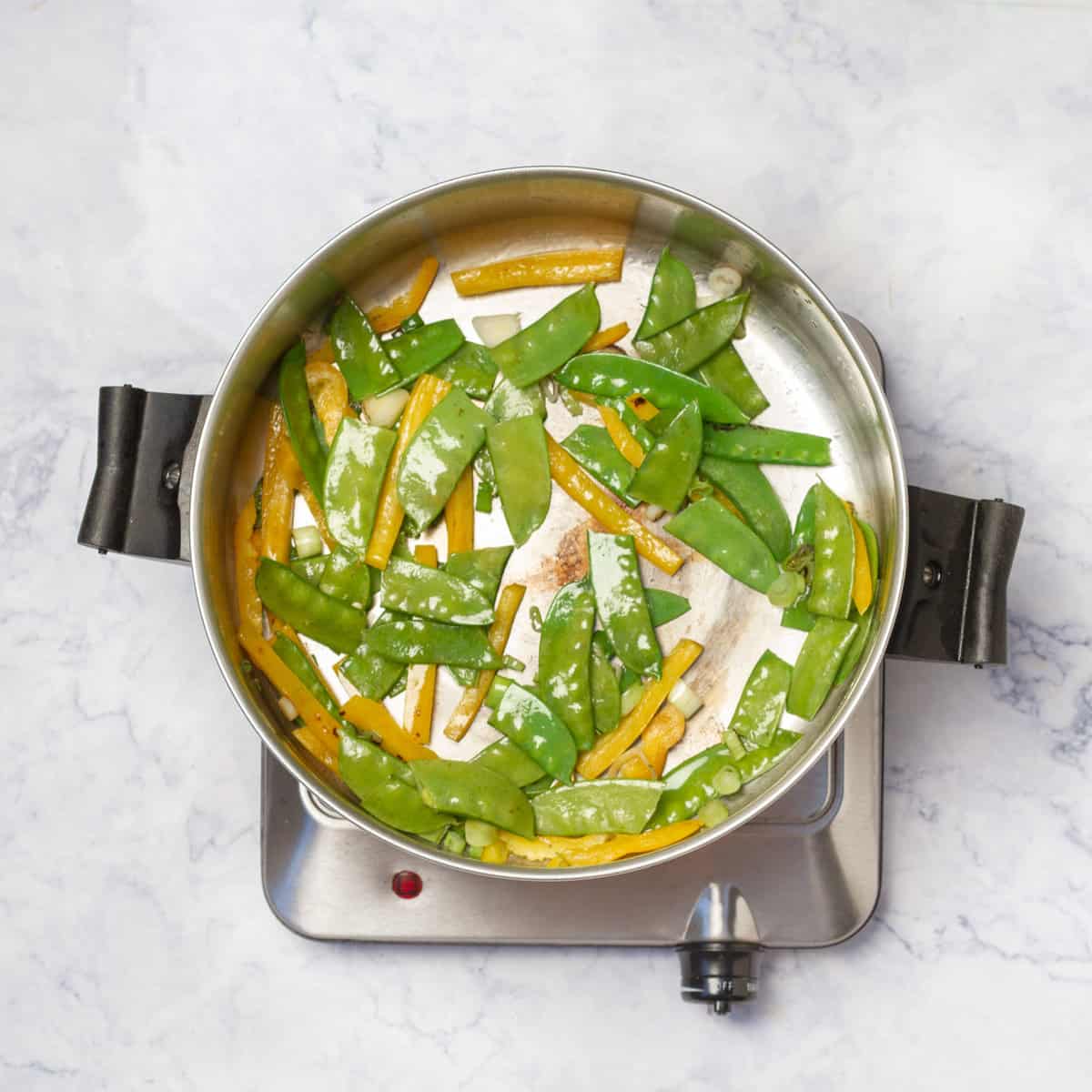 carrots, green onions and yellow bell pepper; stir-fry in a skillet
