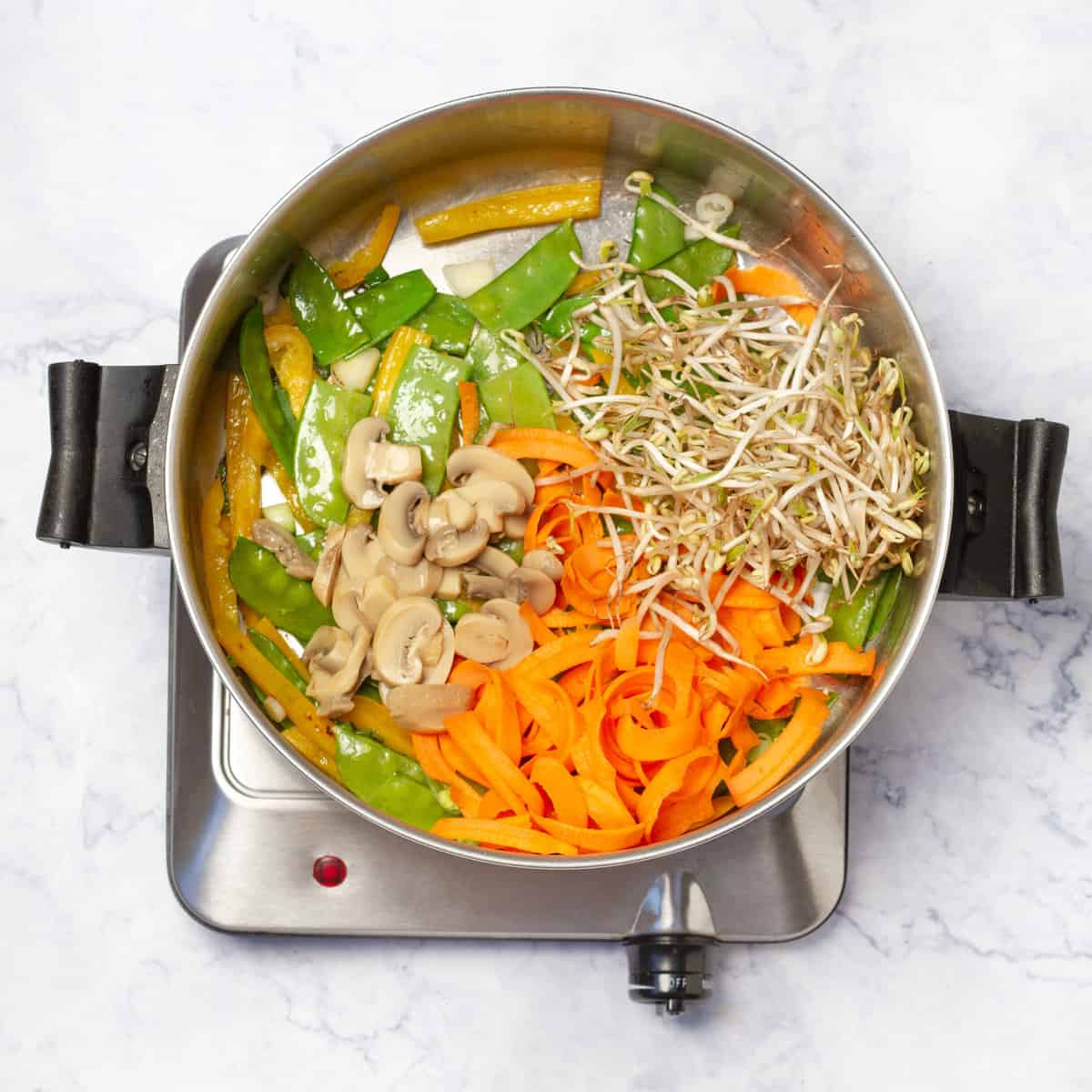 carrots, green onions and yellow bell pepper; stir-fry in a skillet