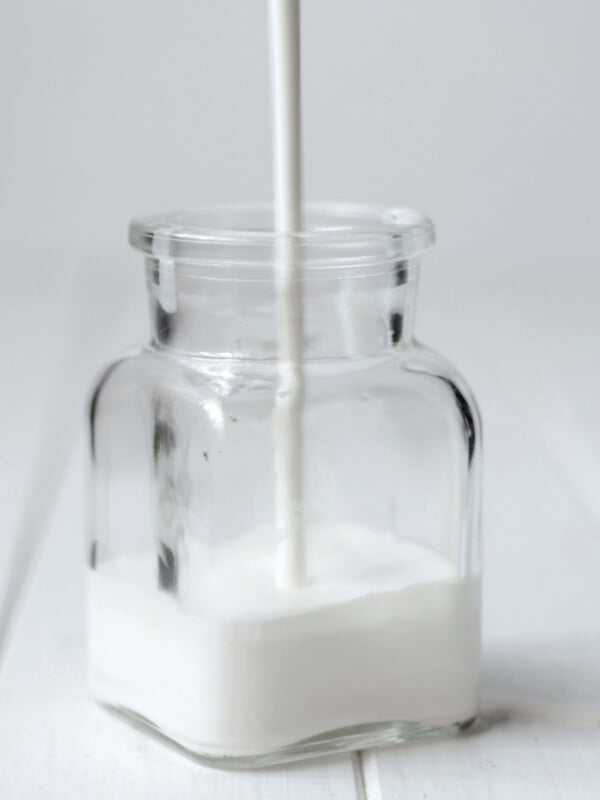 heavy cream pouring into clear jar