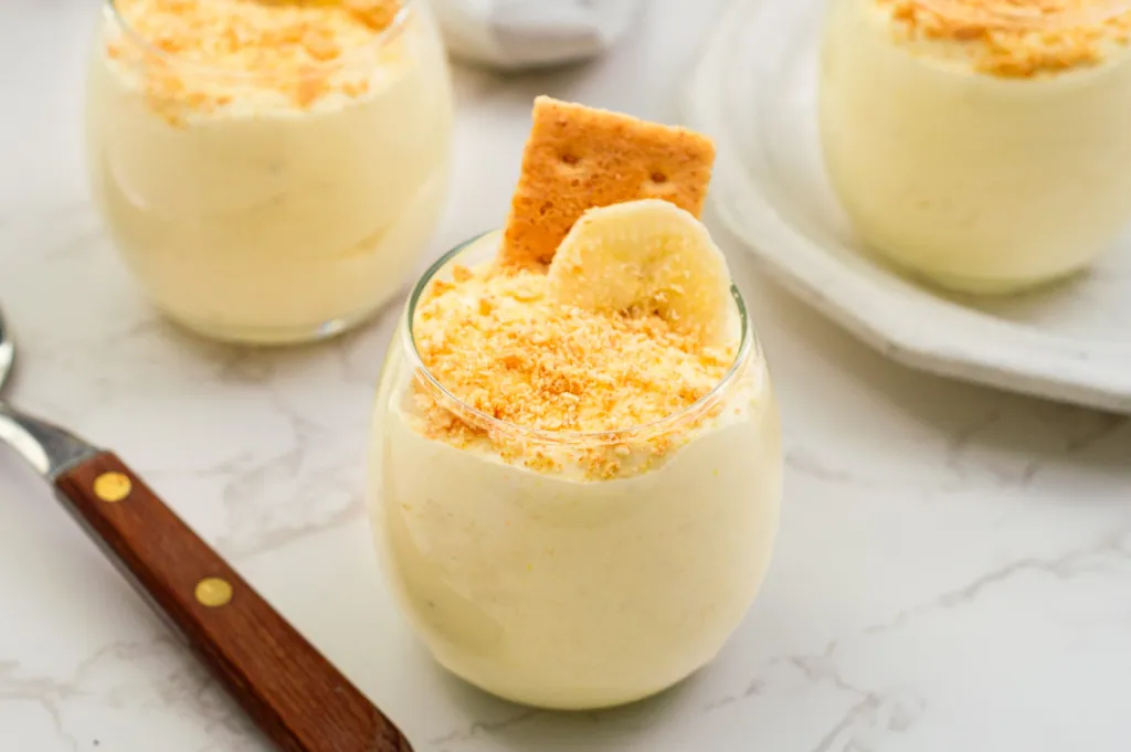 Banana pudding in a glass on a table.