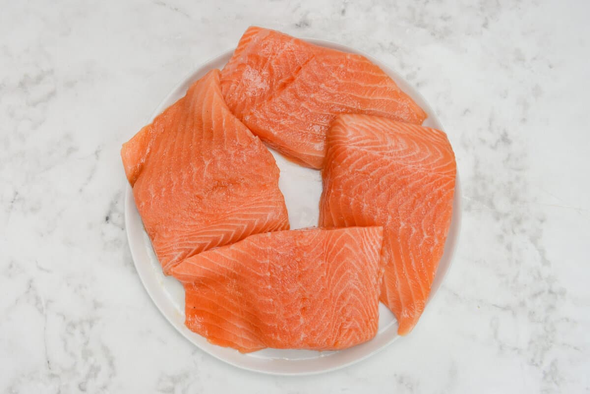 raw marinated salmon filets, pat dry and sitting on a white plate