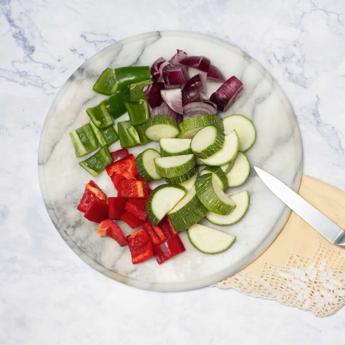 chop the peppers, zucchini, and onion into pieces