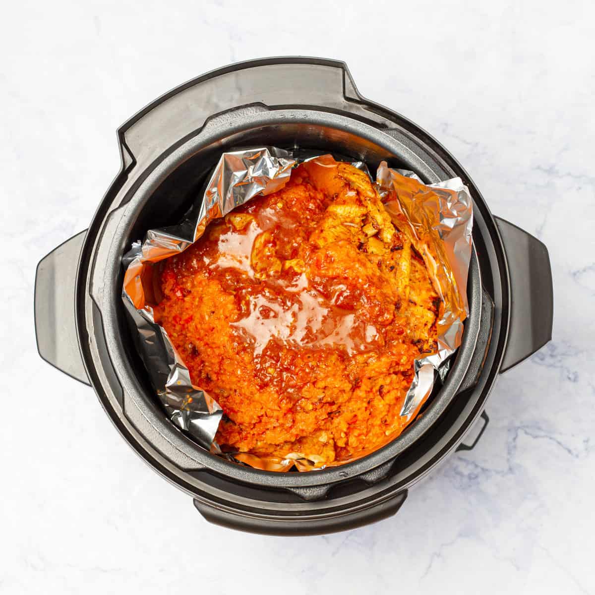sautéed chicken breast fillets on the foil placed in instant pot