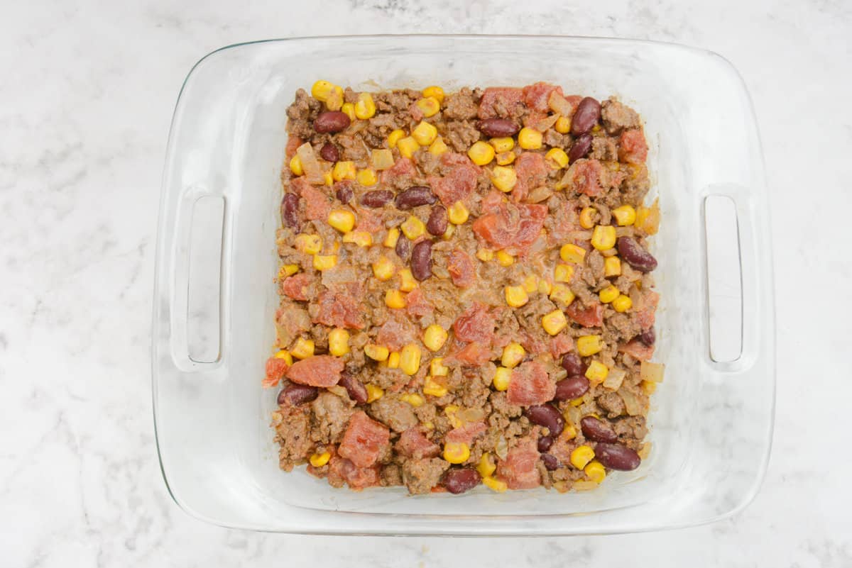 A square casserole dish filled with the Cowboy casserole filling is shown.