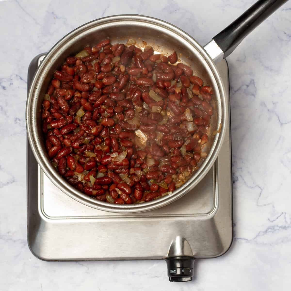 black beans cooking in a saucepan