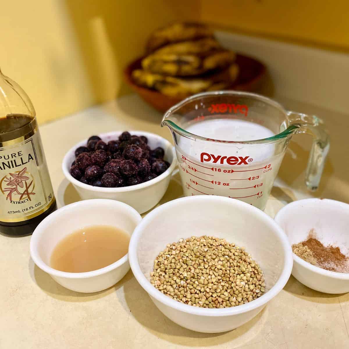Buckwheat porridge and blueberry compote ingredients of buckwheat groats, almond milk, spices, blueberries, lemon juice, stevia, and vanilla.