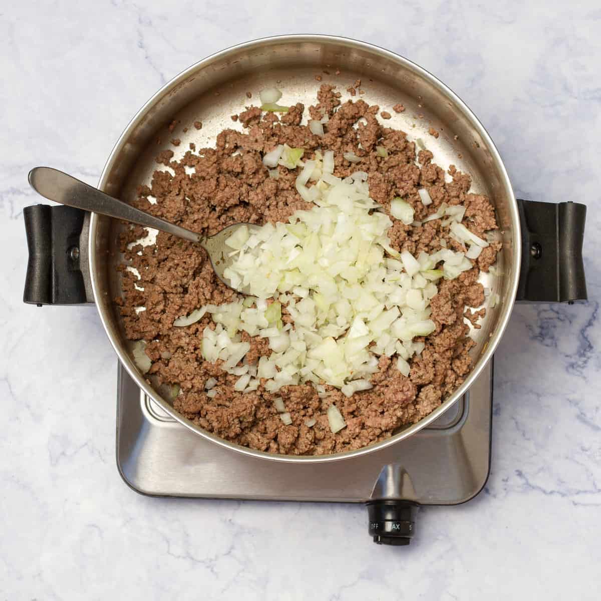 chopped onion and crushed garlic added to ground beef