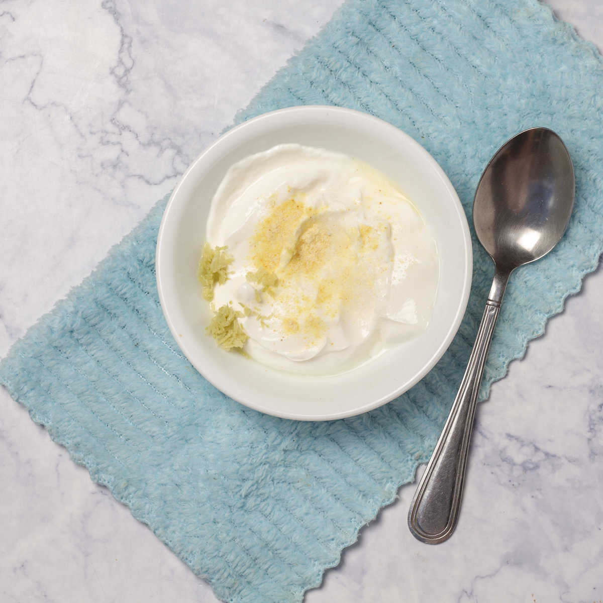 Prepare the yogurt cream by mixing yogurt, garlic, lemon zest, and salt in a small bow, 