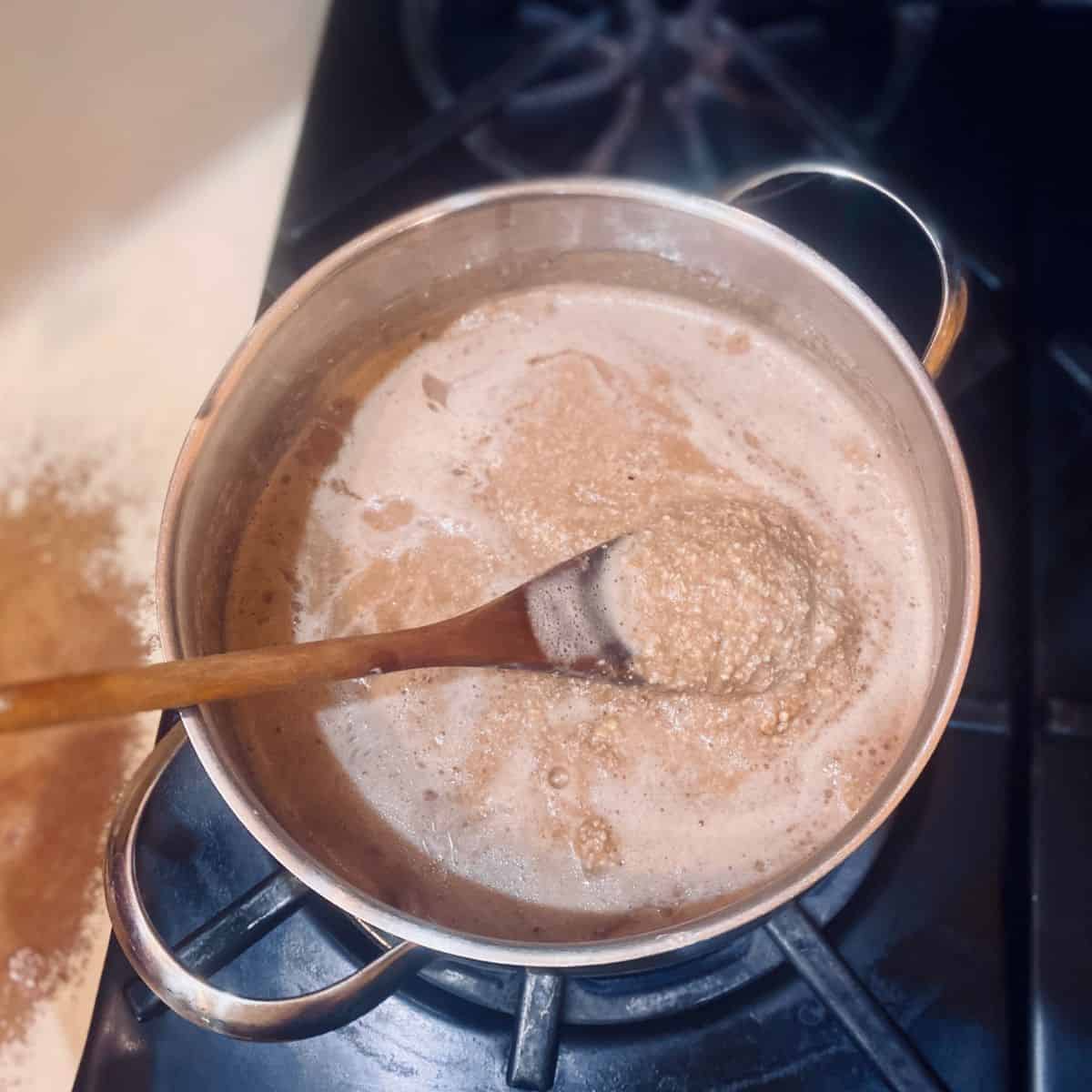 Cook the buckwheat porridge mixture in a pot, stirring frequently, until it thickens. 