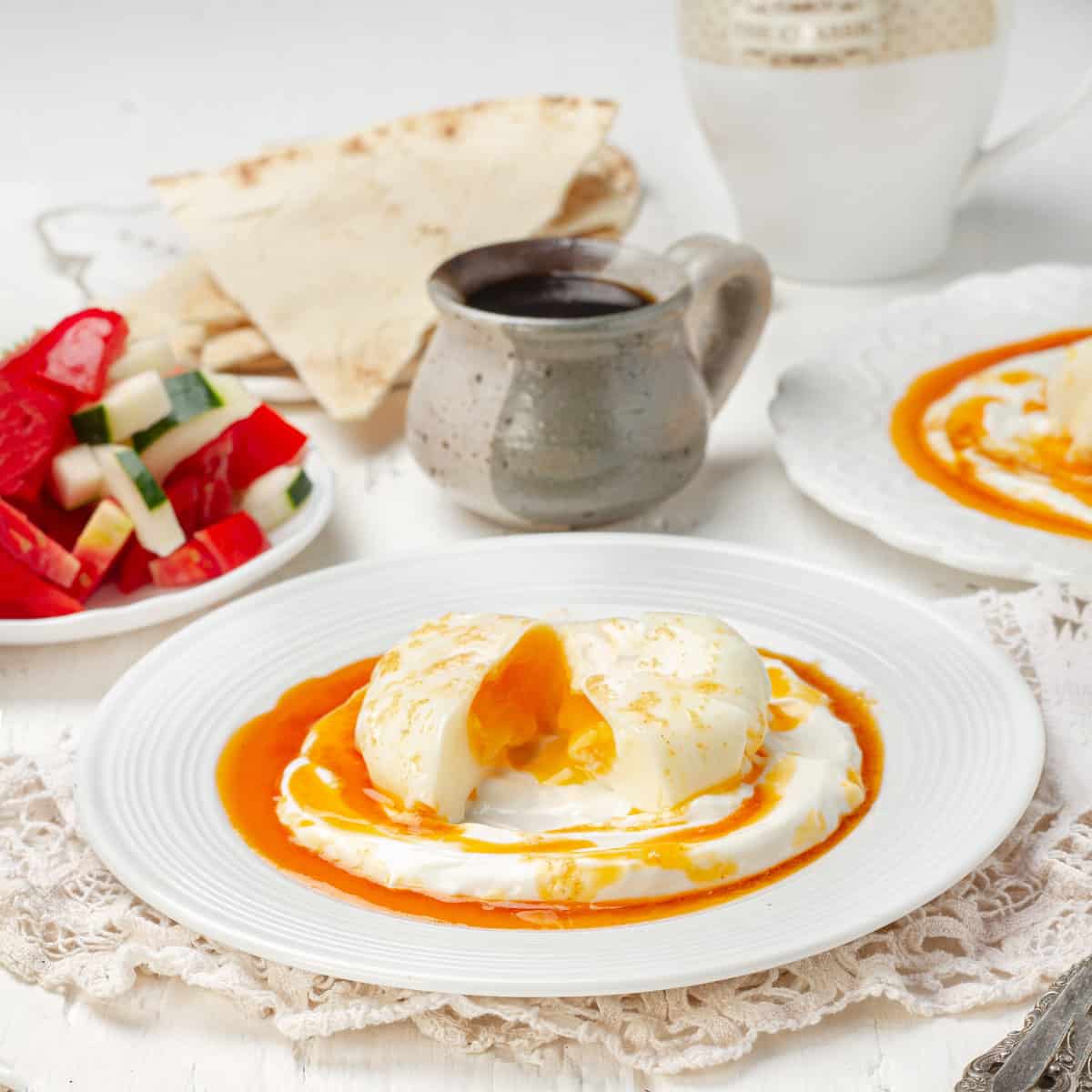 Cilbir, consisting of perfectly poached Turkish eggs atop a bed of plain yogurt and a rich lemon garlic butter sauce.