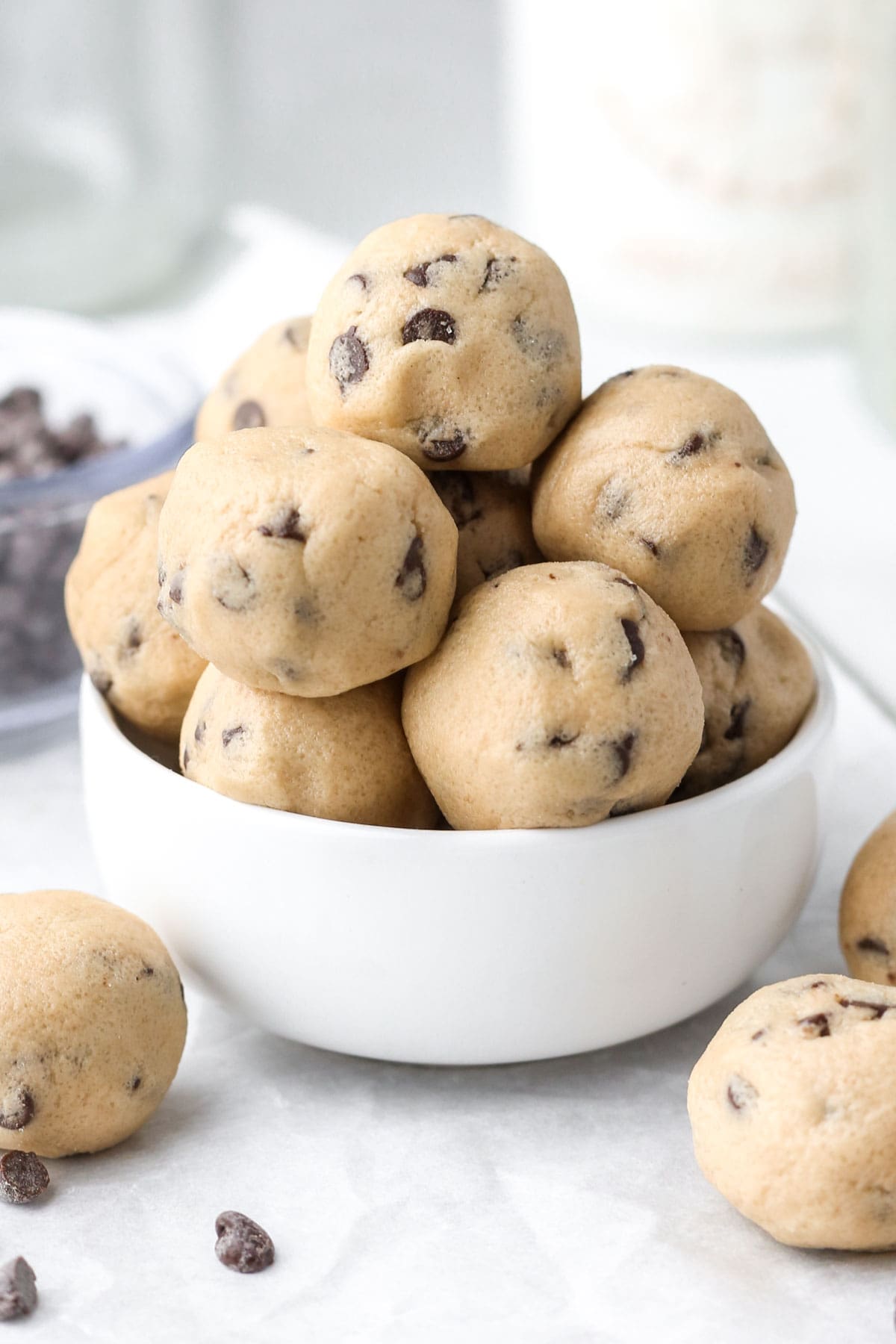 A bowl of edible cookie ball bites on a table.