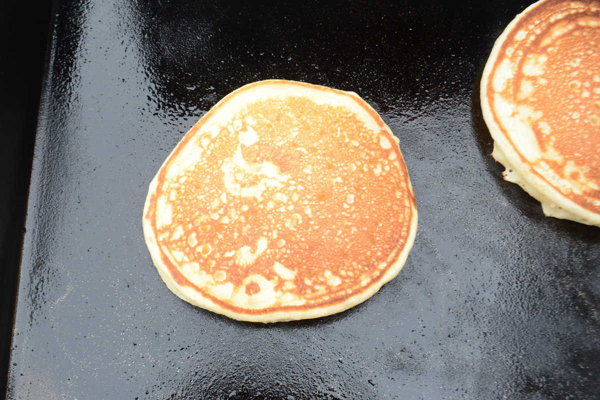 flipped pancake, showing golden brown exterior.