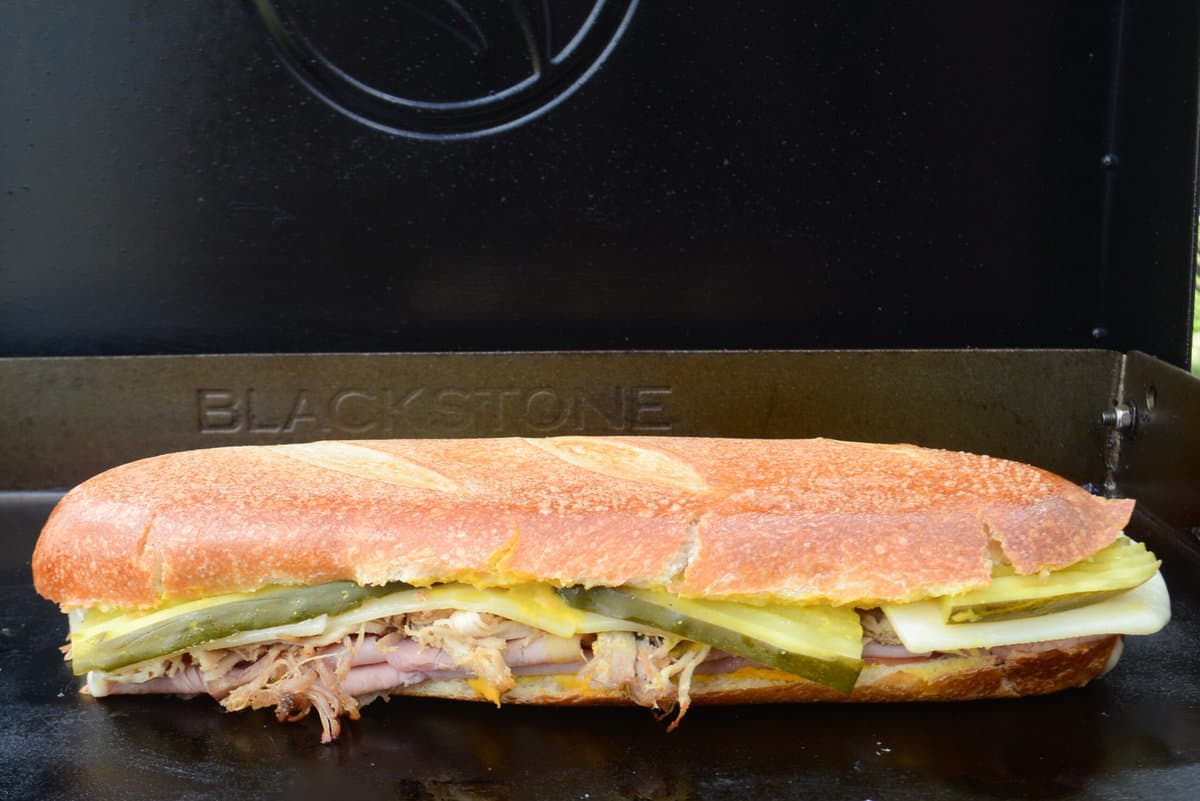 Finished Blackstone Cuban Sandwich, sitting on griddle ready to be served.