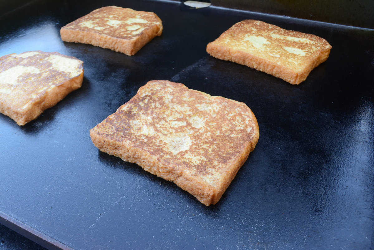 A close up of a golden brown slice of French toast on the Blackstone
