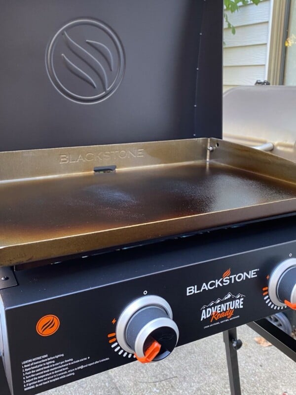 Close up of Blackstone griddle on patio with the lid open