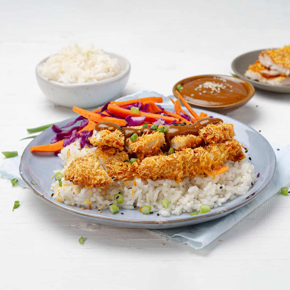 Chicken Katsu platted with a bowl of rice