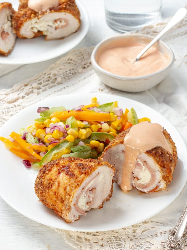 Chicken Cordon Bleu served with sauce and salads