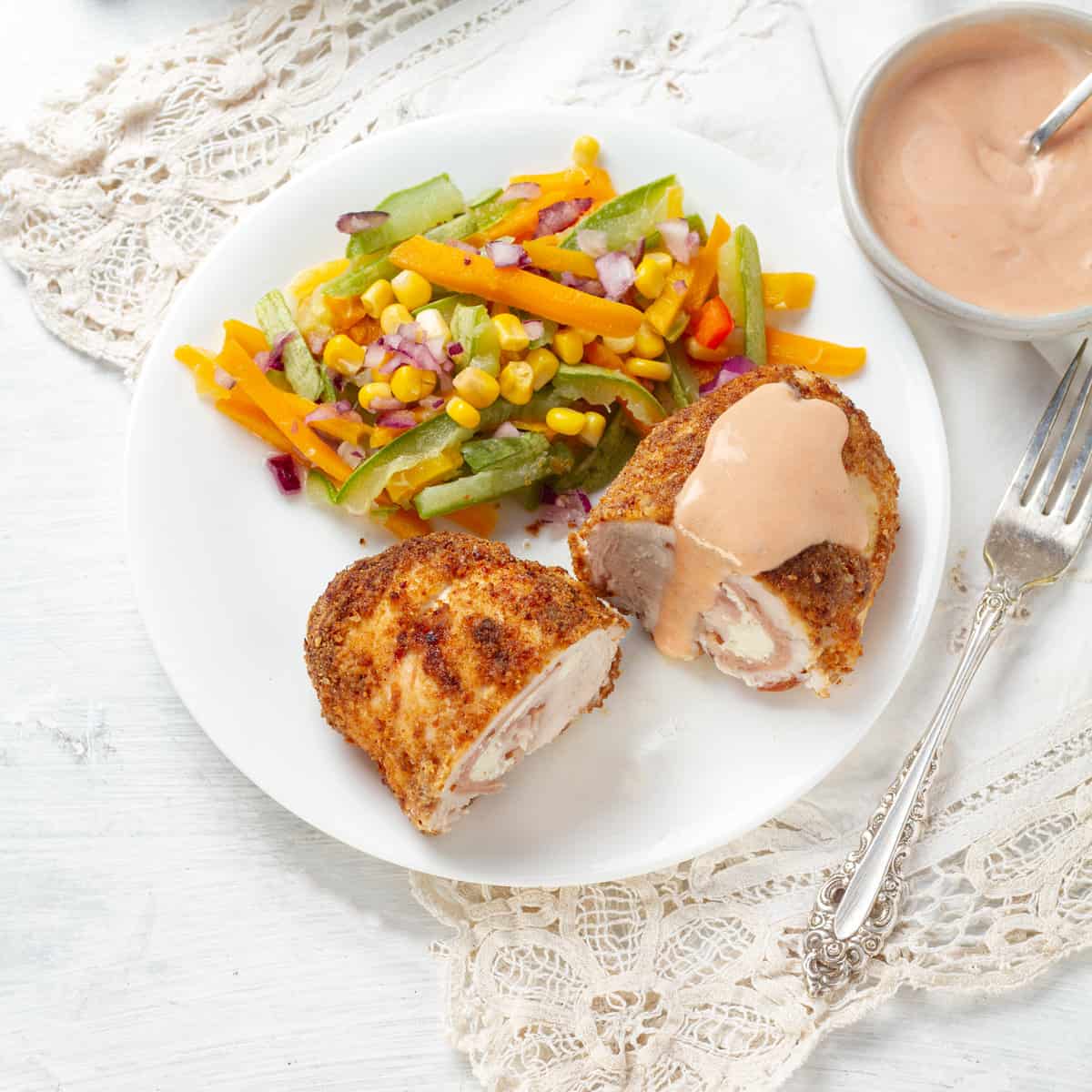 Chicken Cordon Bleu served with sauce and salads
