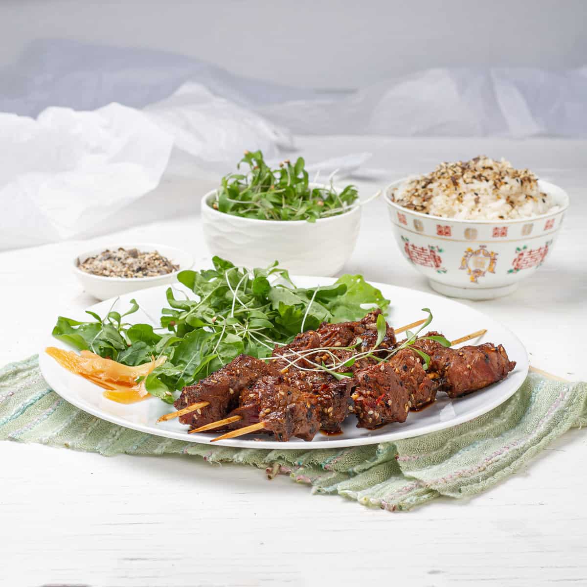 Green Tea Beef Kebabs plated with green salads