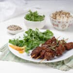 Green Tea Beef Kebabs plated with green salads