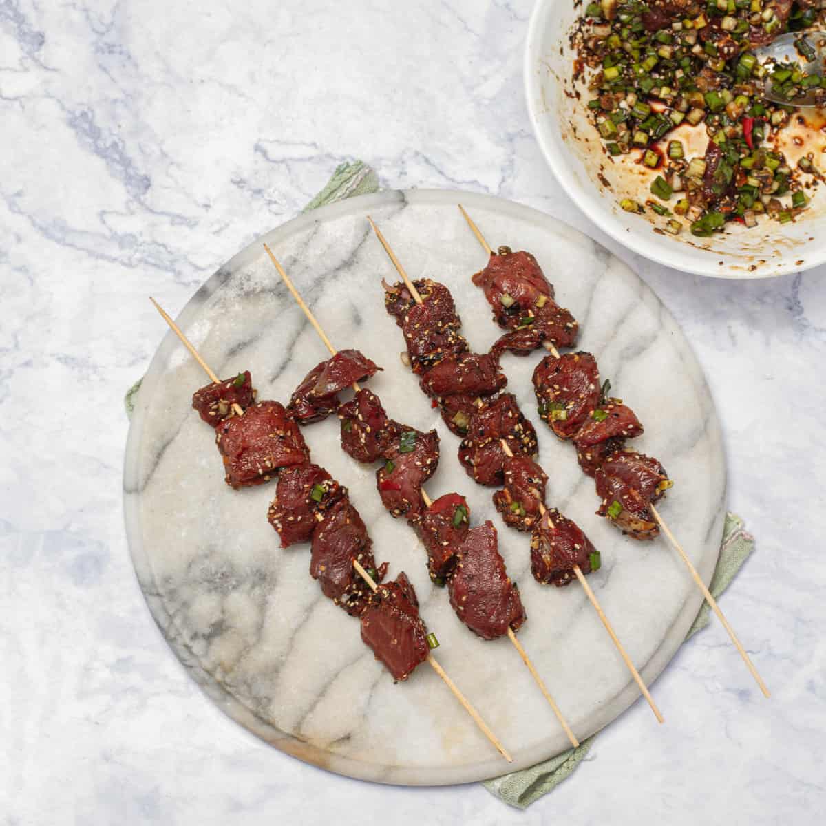 marinated beef cubes thread onto skewers 