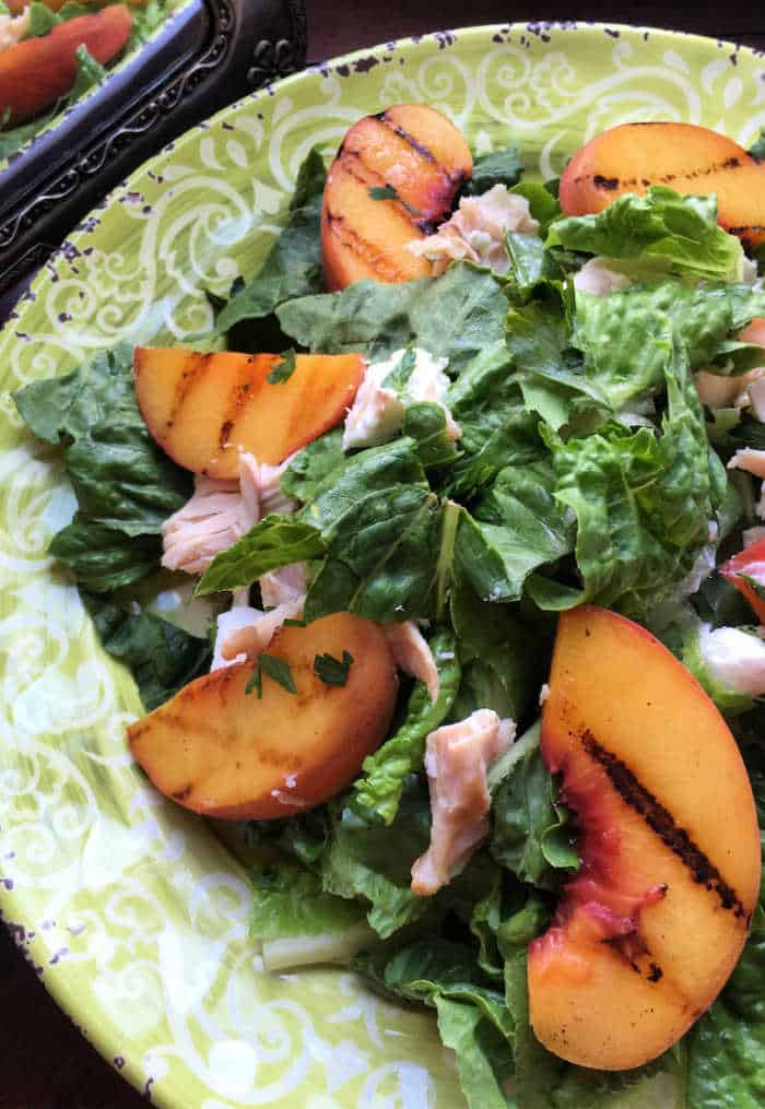 A Grilled Peach Salad on a serving platter.