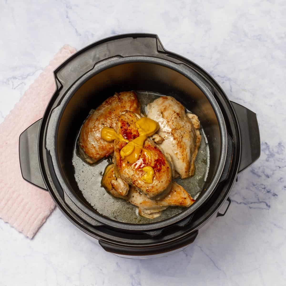 Instant pot with breast chicken and add the mustard, honey, Splenda, and chicken broth