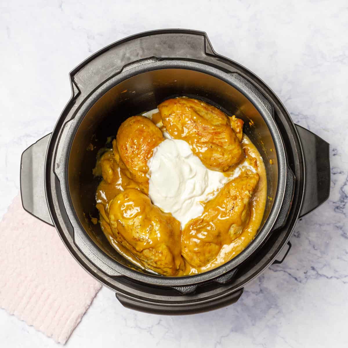 Greek yogurt added into cooked Honey Mustard Garlic Chicken 