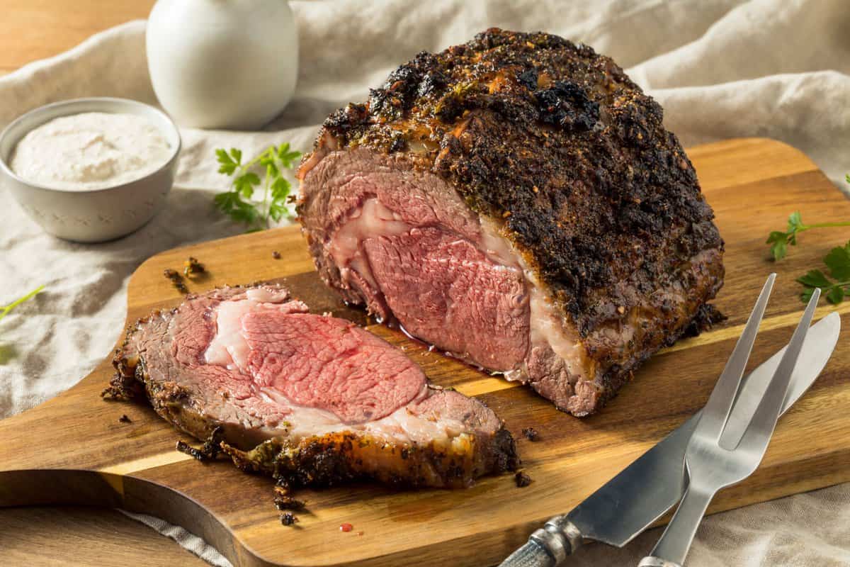 Prime rib perfectly cooked with a cut made out from the end of the steak