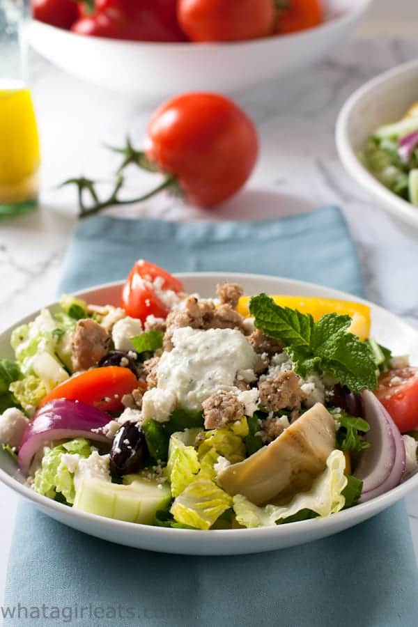 A Greek Gyros Salad in a bowl on a table.