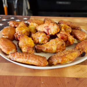 smoked crispy wings on white plate
