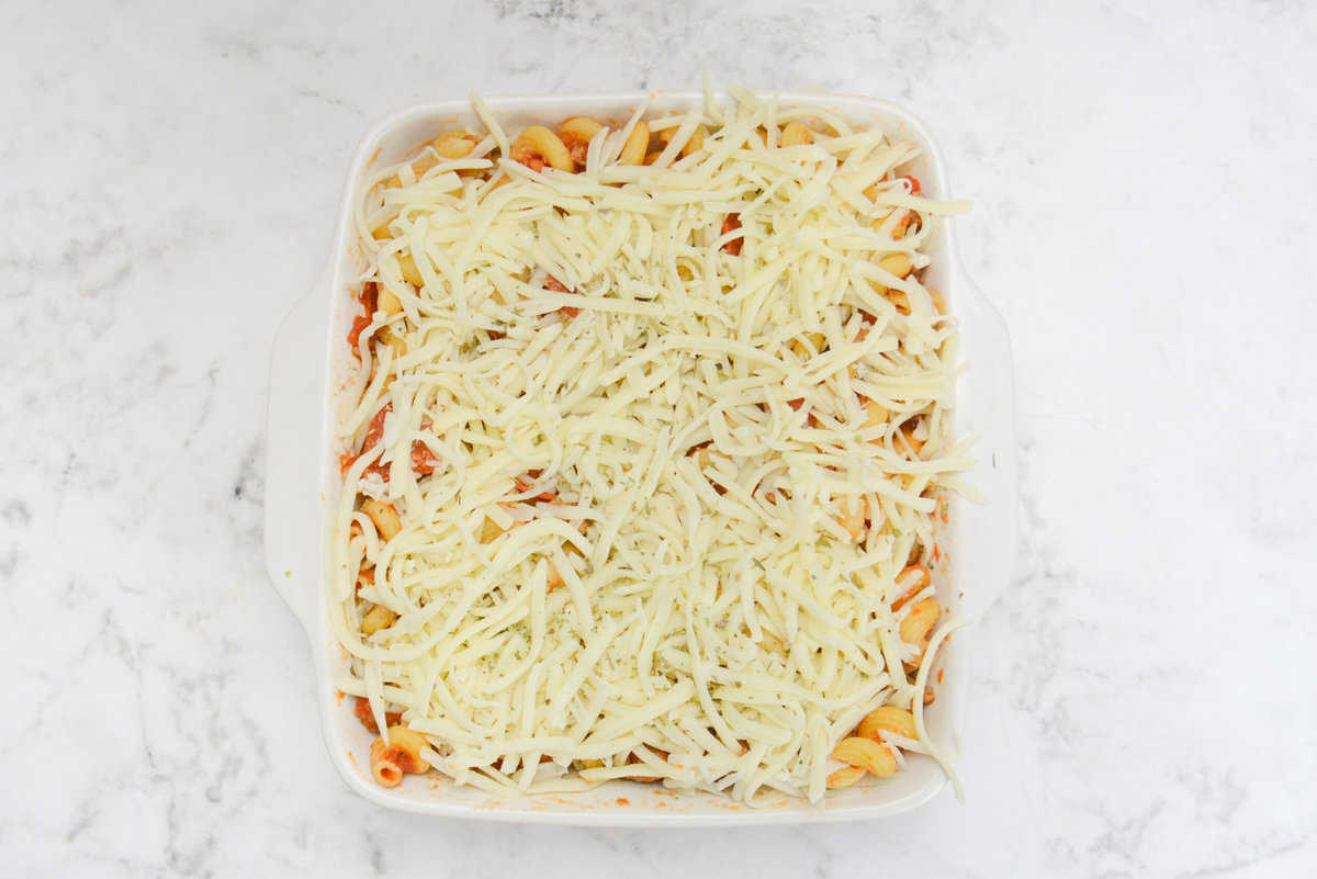 The filled casserole dish is now topped with shredded mozzarella 