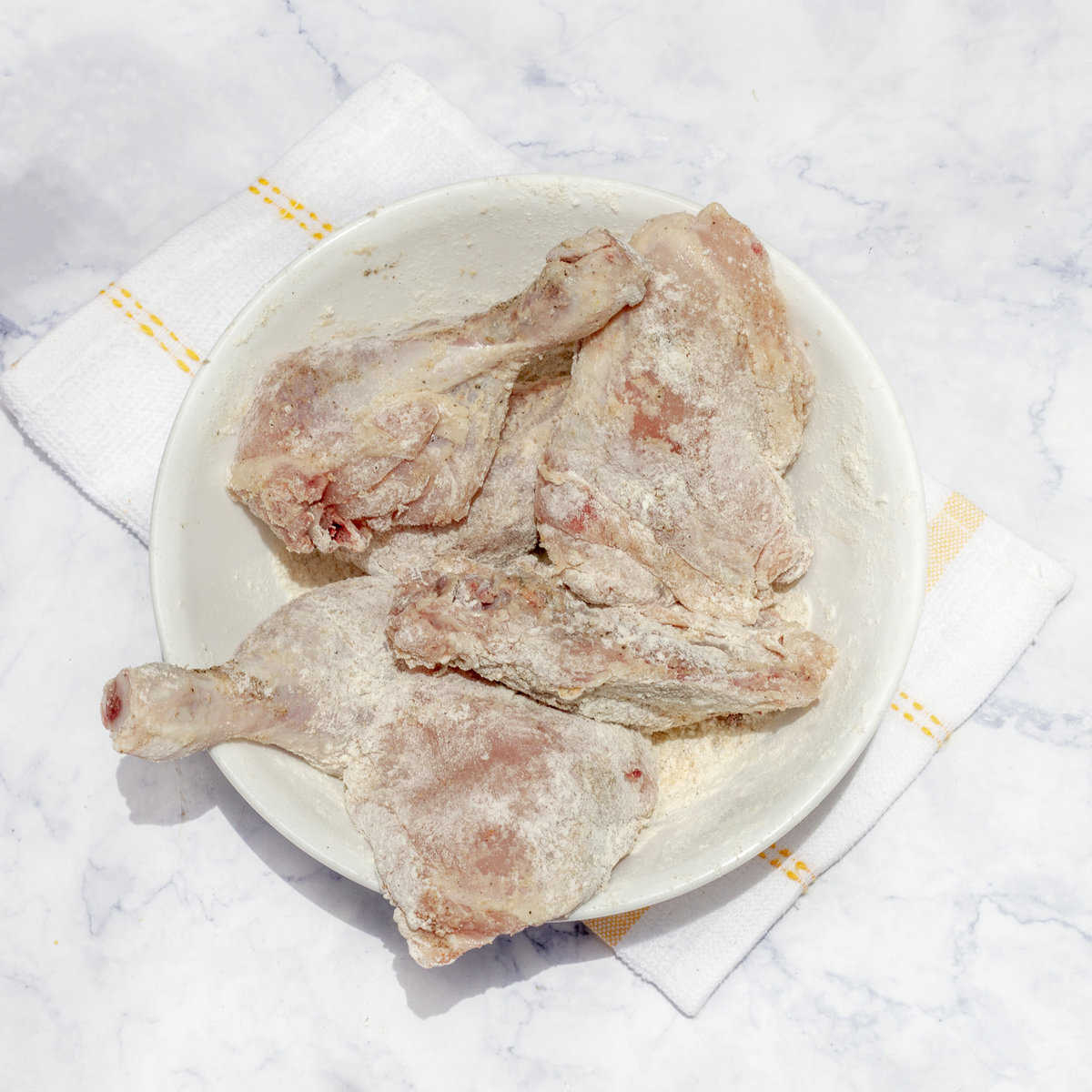 Dredge chicken thighs in flour