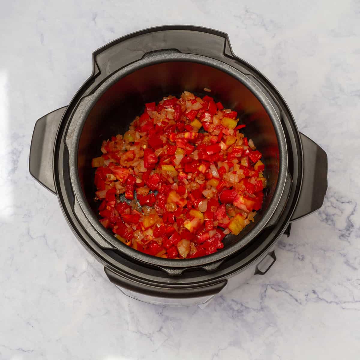 add the diced onion and sliced red bell pepper in instant pot