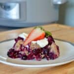 Plated slow cooker cobbler with fresh strawberries