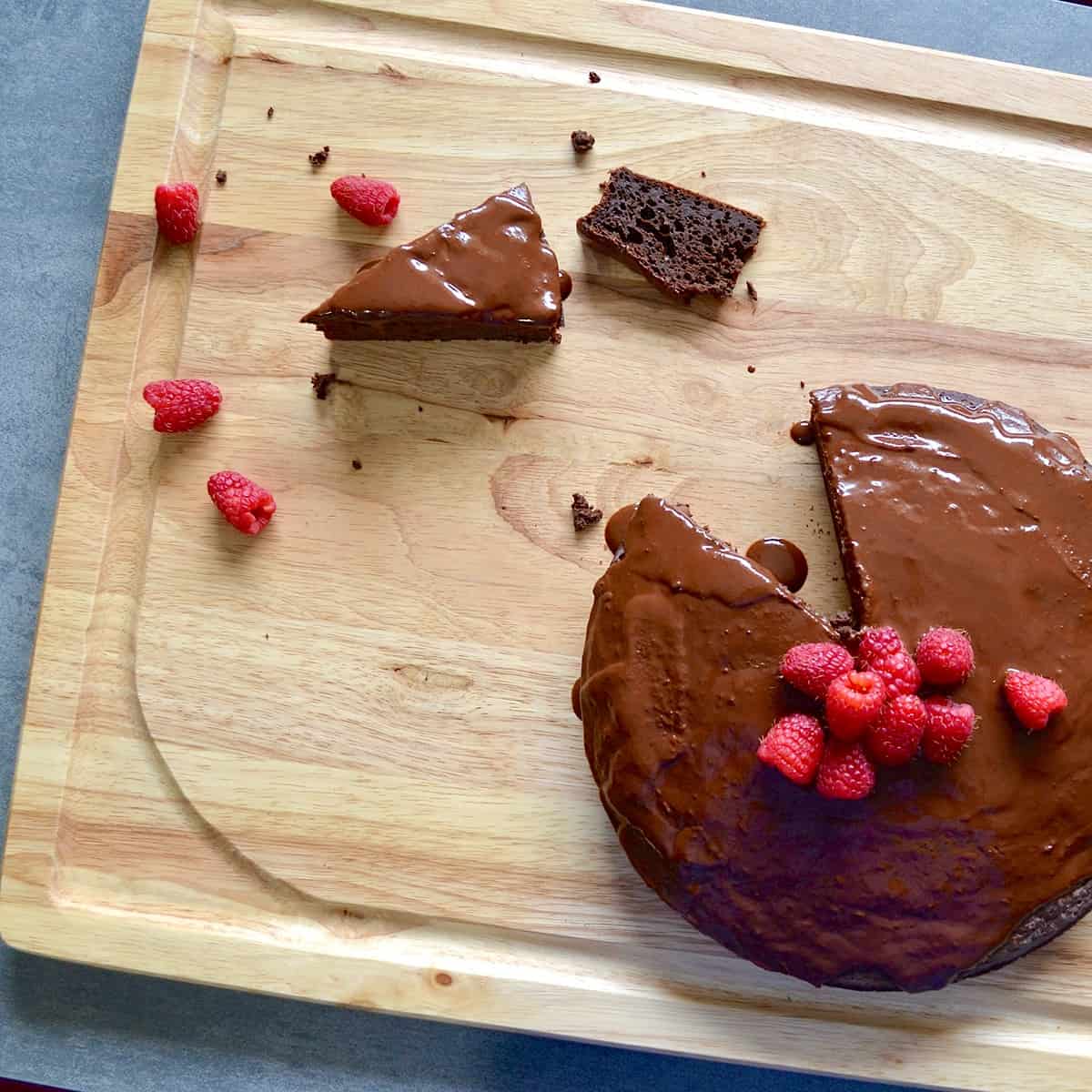 Sliced chocolate mud cake with raspberries