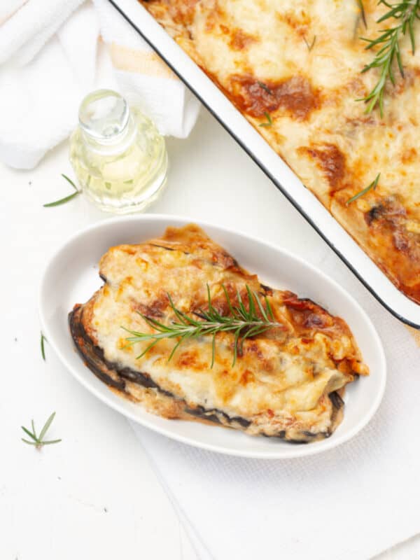 Eggplant Parmesan served in plate and baking tray