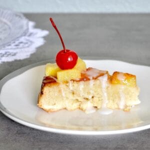 Slice of cake with pineapples and cherries