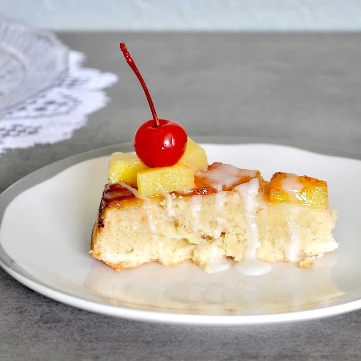 Slice of cake with pineapples and cherries