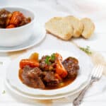 Beef Stew served in a plate with bread