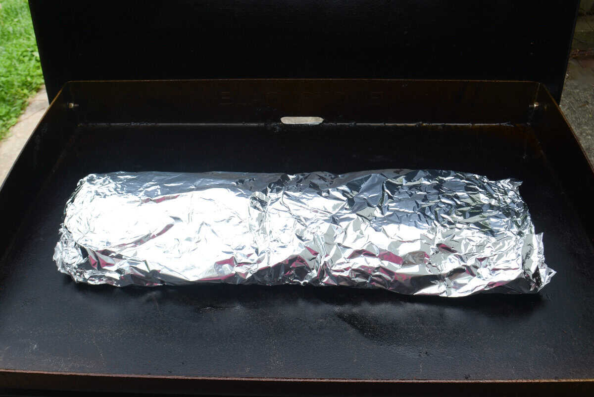 The ribs wrapped in foil on the Blackstone 