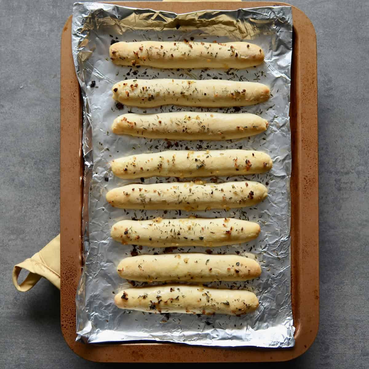 Baked WW garlic breadsticks on a baking sheet