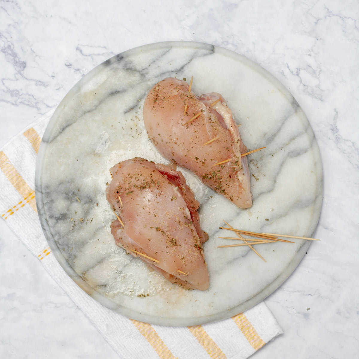 Secure the openings of the chicken breasts with toothpicks