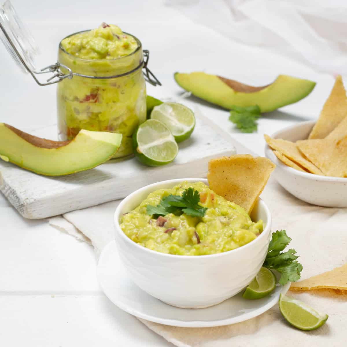 Guacamole served in a bowl with lemon and avocado slices