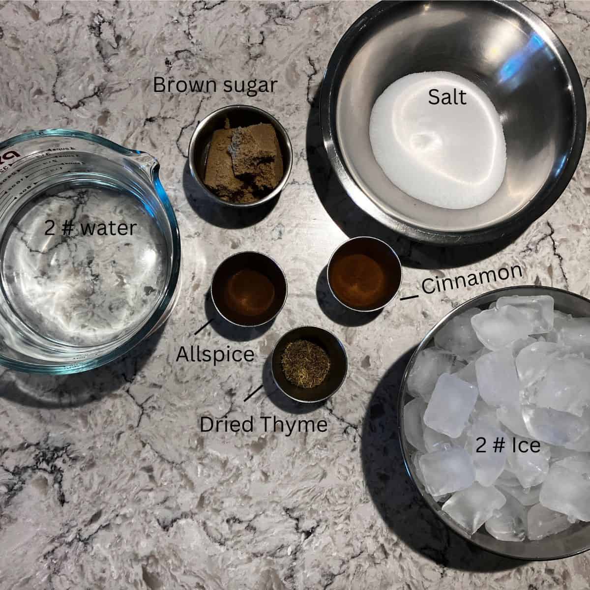 Brine ingredients for smoked ribs, including ice, water, salt, brown sugar, allspice, cinnamon, and dried thyme in separate dishes. 