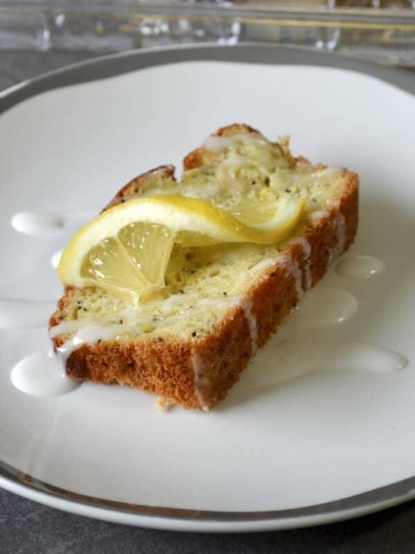 Slice of lemon bread with glaze and lemon slice