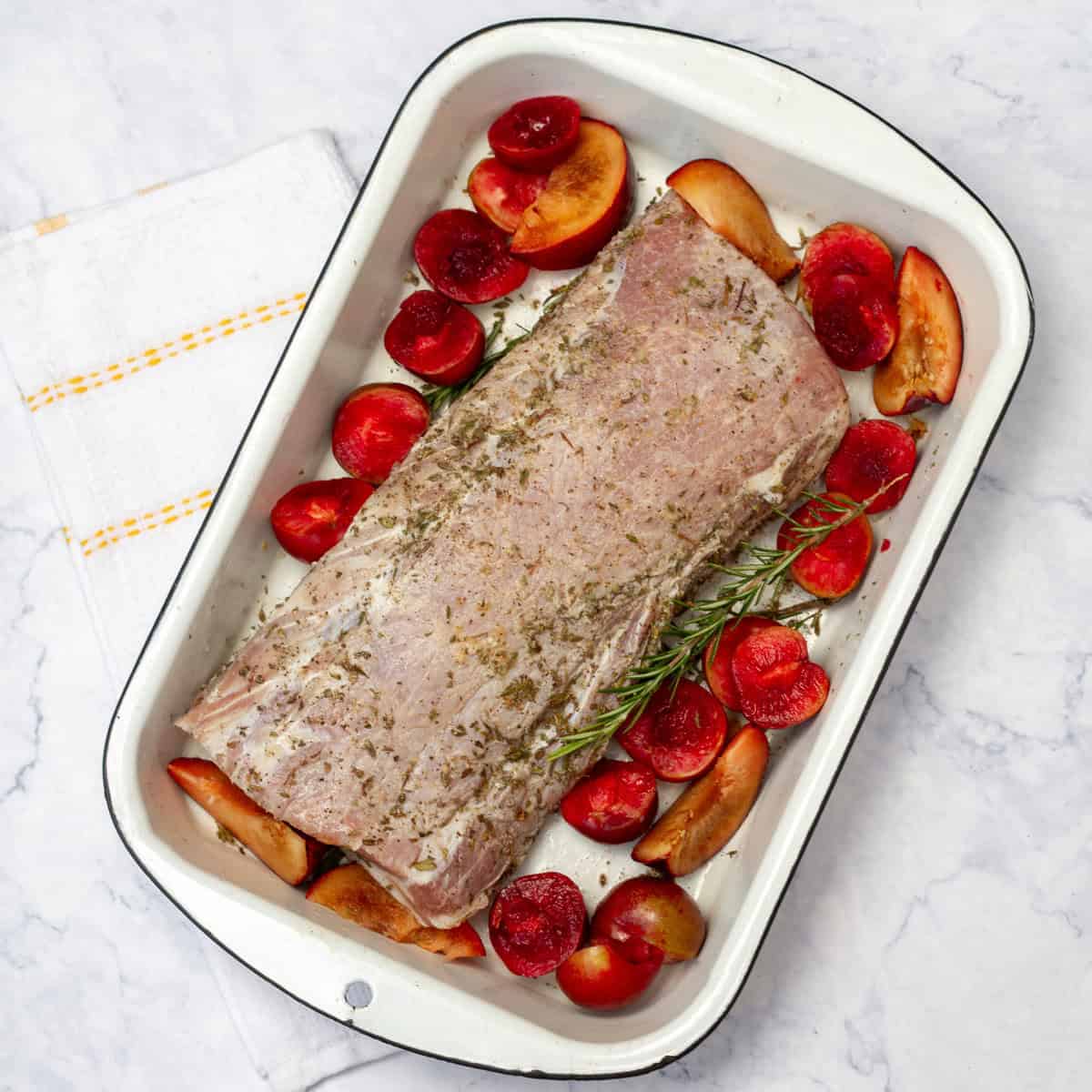 Pork loin with plums in baking tray